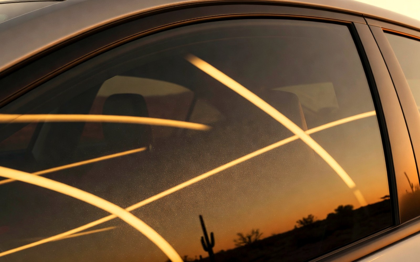 Tinted vehicle side glass with warm measurement-like reflections for Arizona tint law guidance
