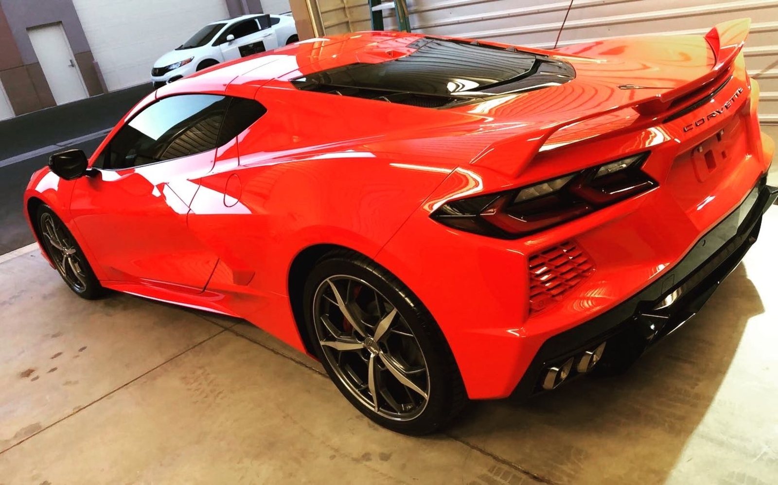 Red Chevrolet Corvette photographed inside the Chandler vehicle-protection shop